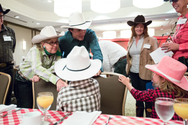Justin Trudeau, Xavier, and Ella-Grace attend a pancake breakfast at the 2014 Calgary Stampede and meet Elizabeth May. July 4, 2014.